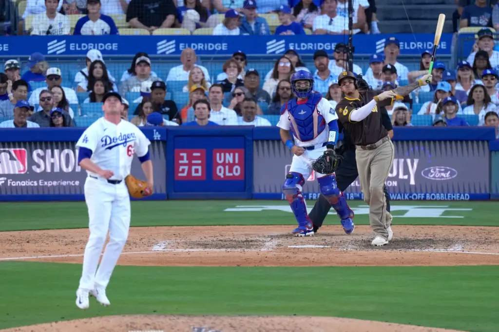 San Diego Padres’ Manny Machado, right, hits a three-run home...