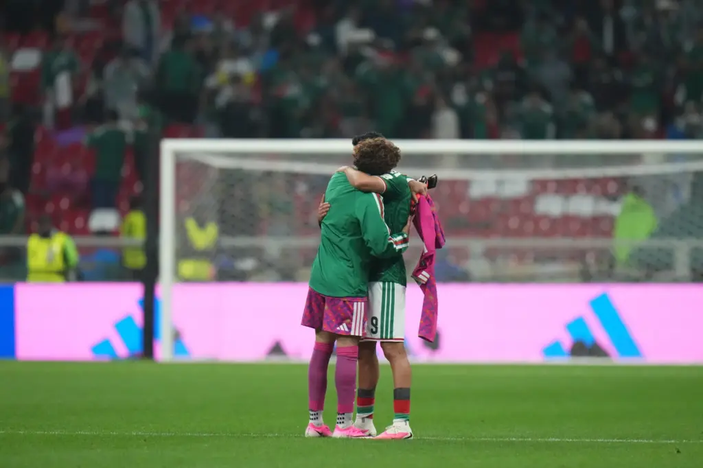 Mexico’s Raul Jimenez (9) hugs goalkeeper Guillermo Ochoa (13) after...