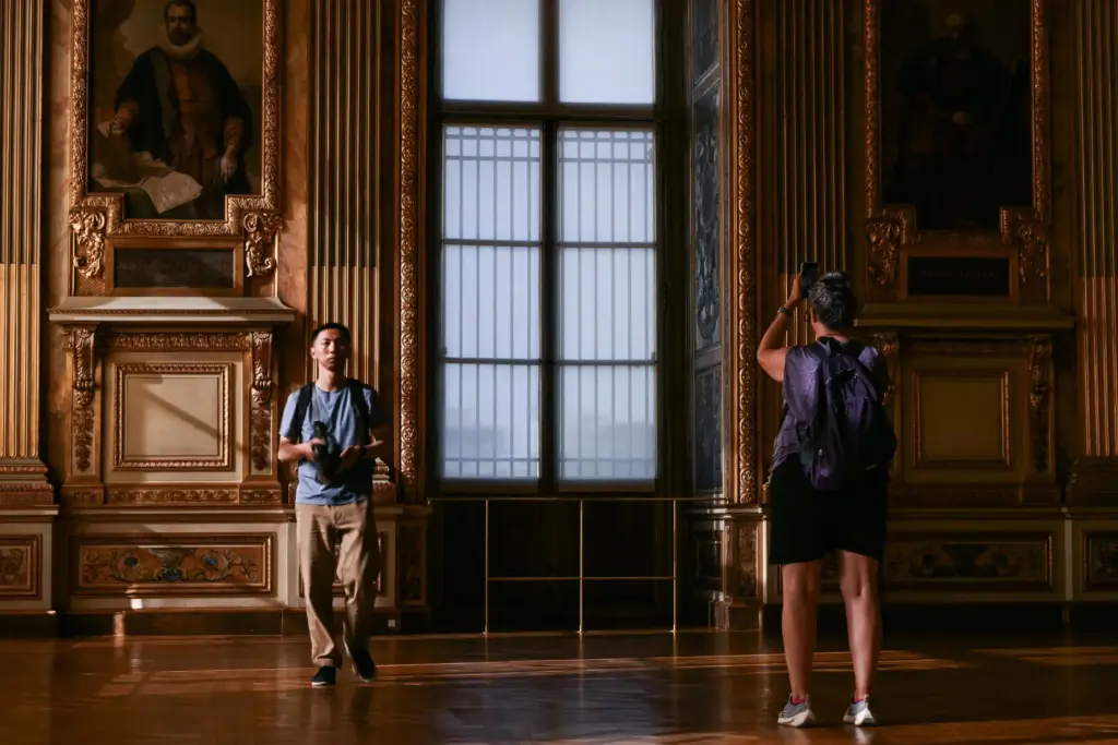 Visitors take a picture of the window which was broken...
