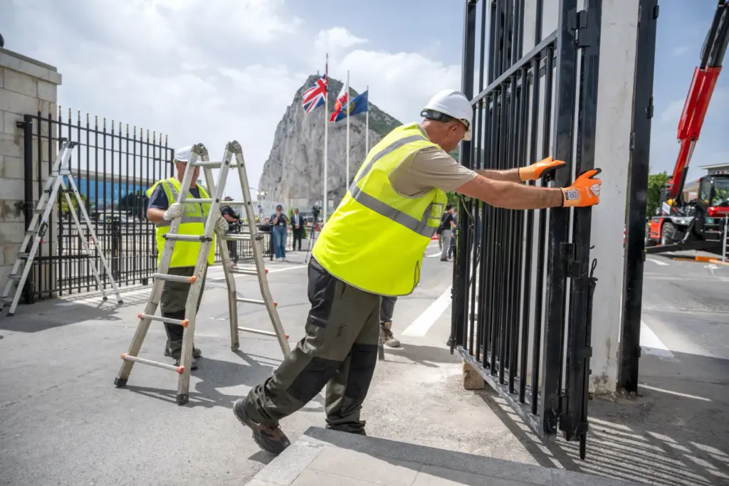 Workers remove the fence separating Gibraltar from Spain.