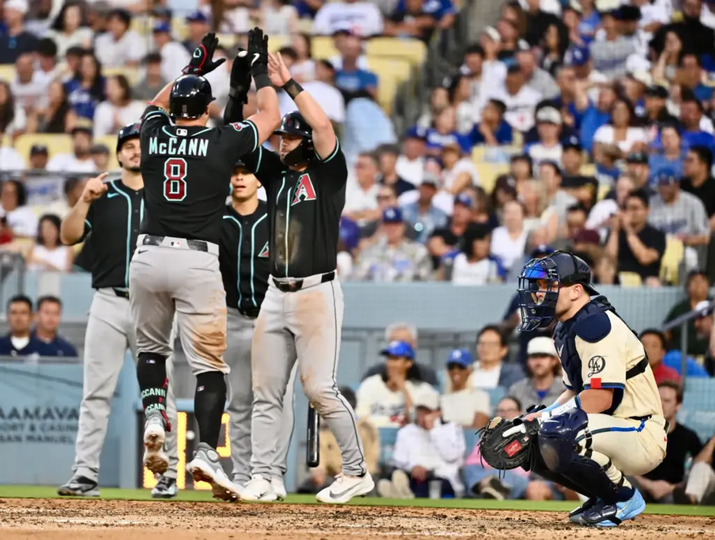 James McCann of the Arizona Diamondbacks high fives teammates after...