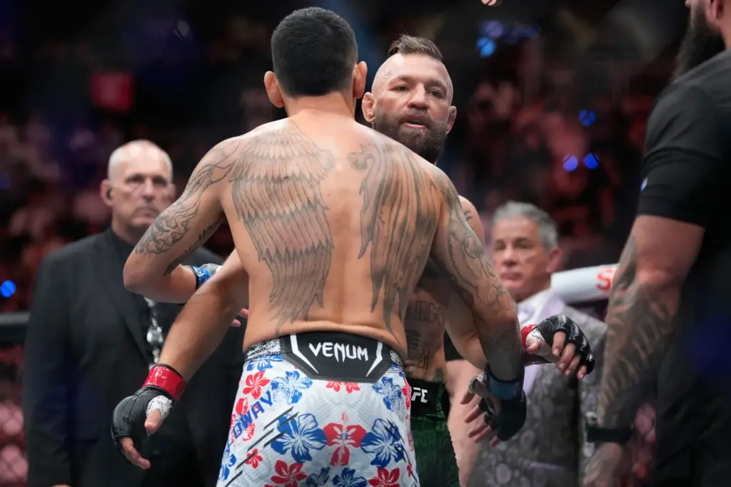 Conor McGregor, right, embraces Max Holloway after McGregor lost in...