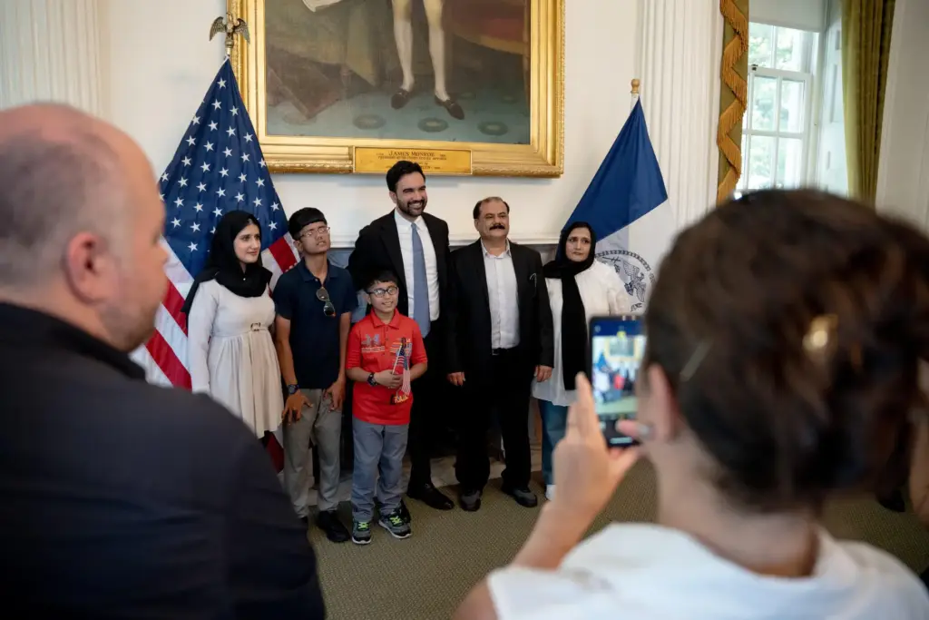 New York Mayor Zohran Mamdani talks with a group of...