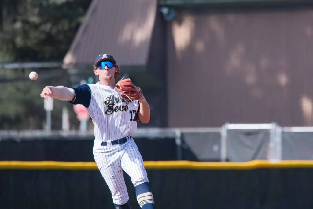 Arroyo Seco Saints shortstop Bryce Robinette sligs a ball to...