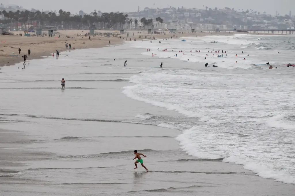 Beachgoers enjoy mild temperatures near the Santa Monica Pier on...