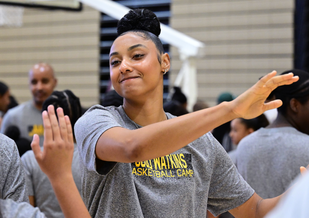 JuJu Watkins high fives some of the girls in the...