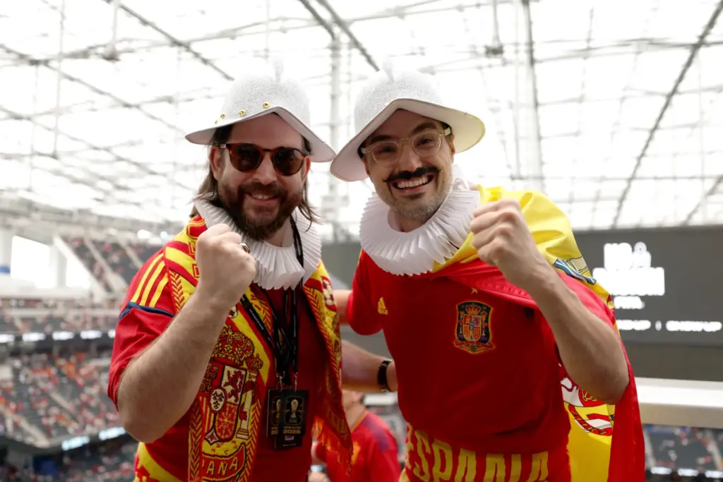 Two Spain fans react to the camera prior to the...