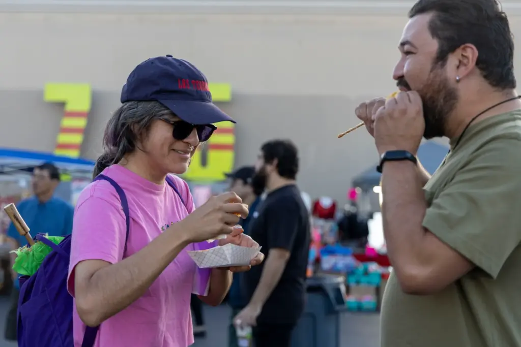 Dorian Romero (left) eats tornado fries with Rodolfo Curiel on...