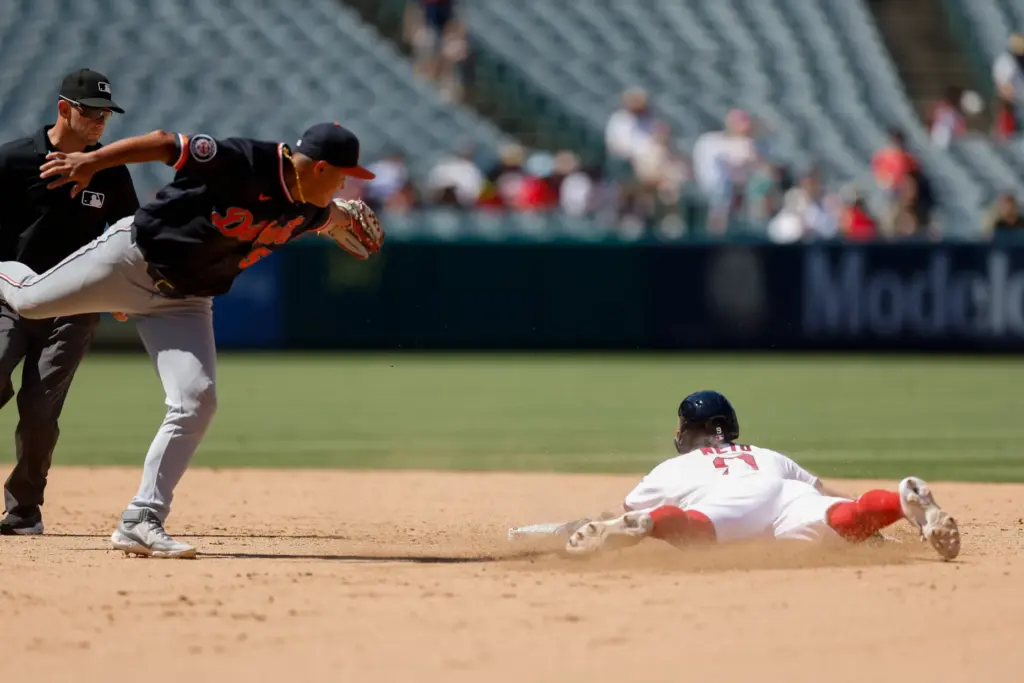 Angels’ Zach Neto, right, slides into second base as Detroit...