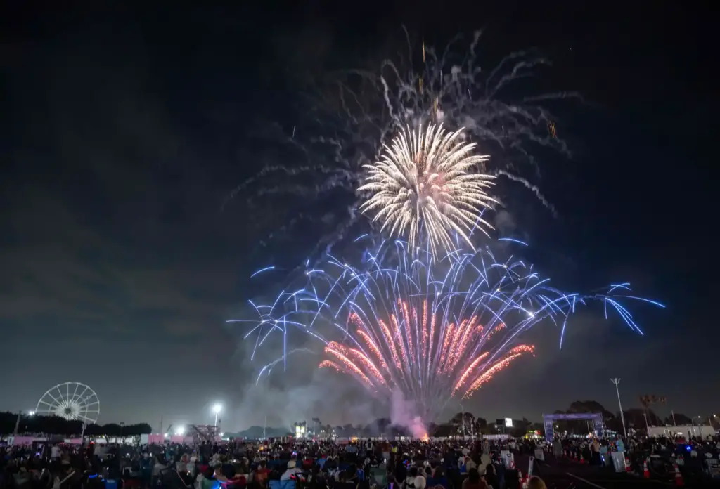 Fireworks explode over the OC Fair Event Center in Costa...