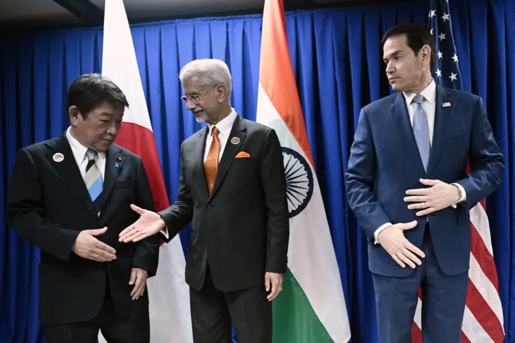 Japan’s Foreign Minister Toshimitsu Motegi, left, shakes hands with India’s...