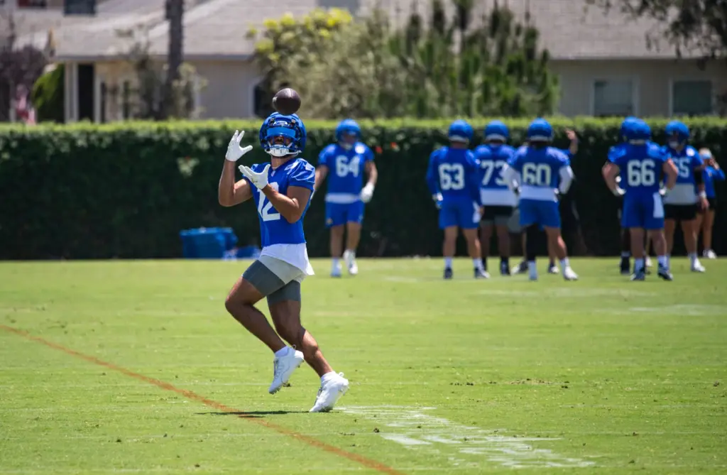 Los Angeles Rams wide receiver Puka Nacua reels in a...
