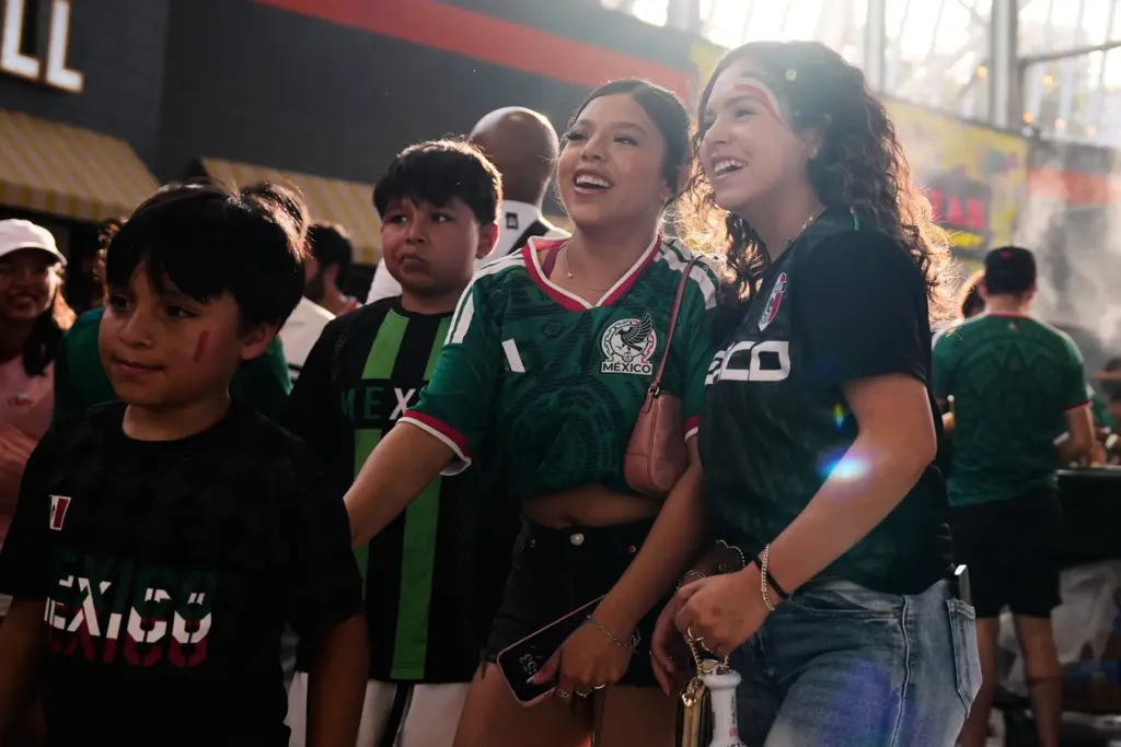 Mexico fans in Houston find their seats before watching a...