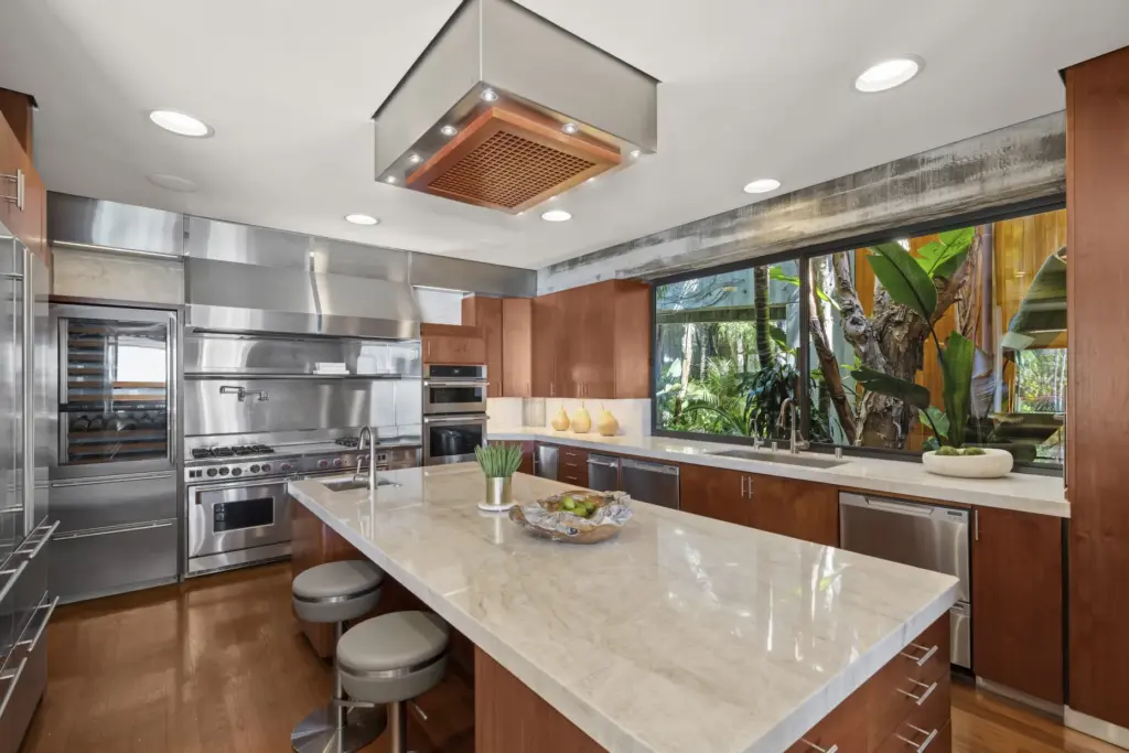The gourmet kitchen features an oversized island and professional-grade appliances....