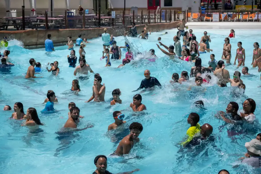 Families cool off in the Shaka Bay wave pool at...