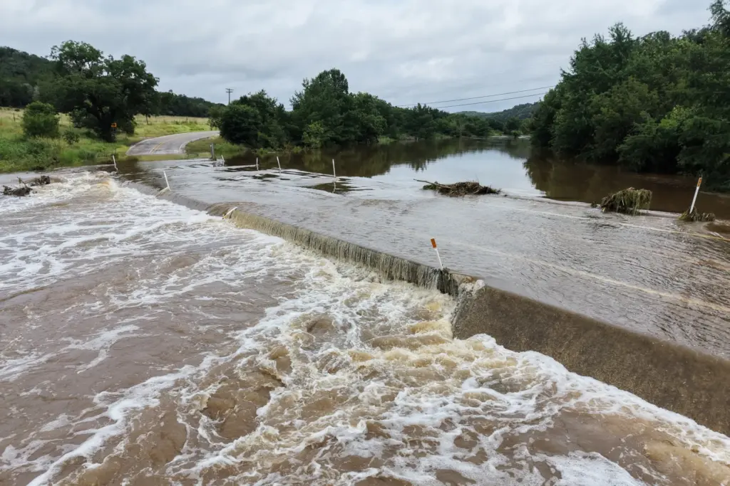 The Guadalupe River floods a crossing after a series of...
