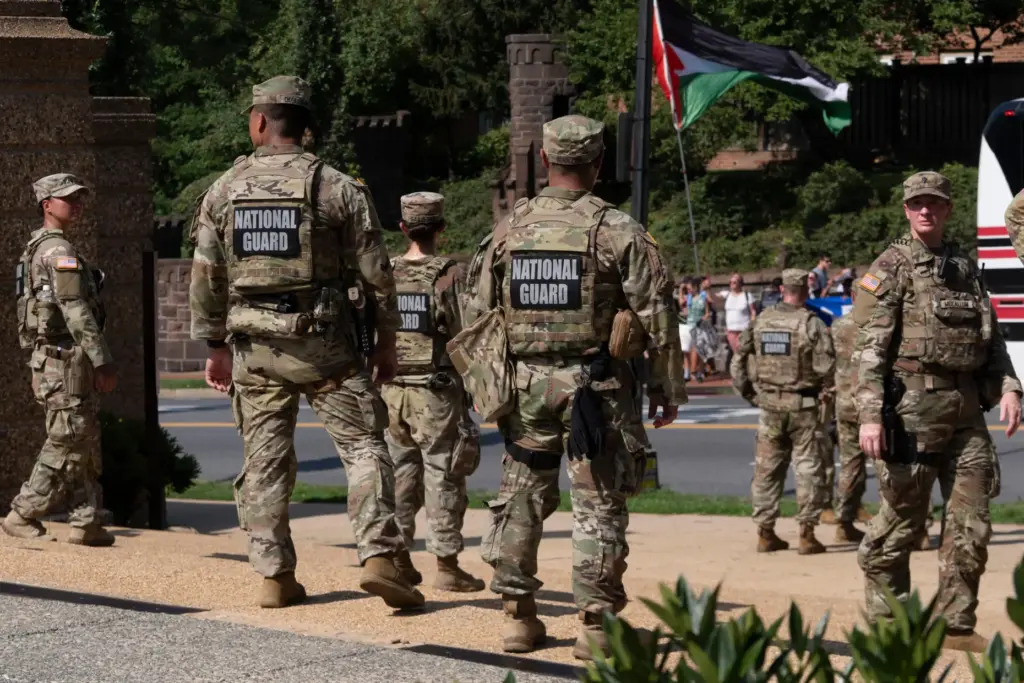 Members of the National Guard form a security line as...