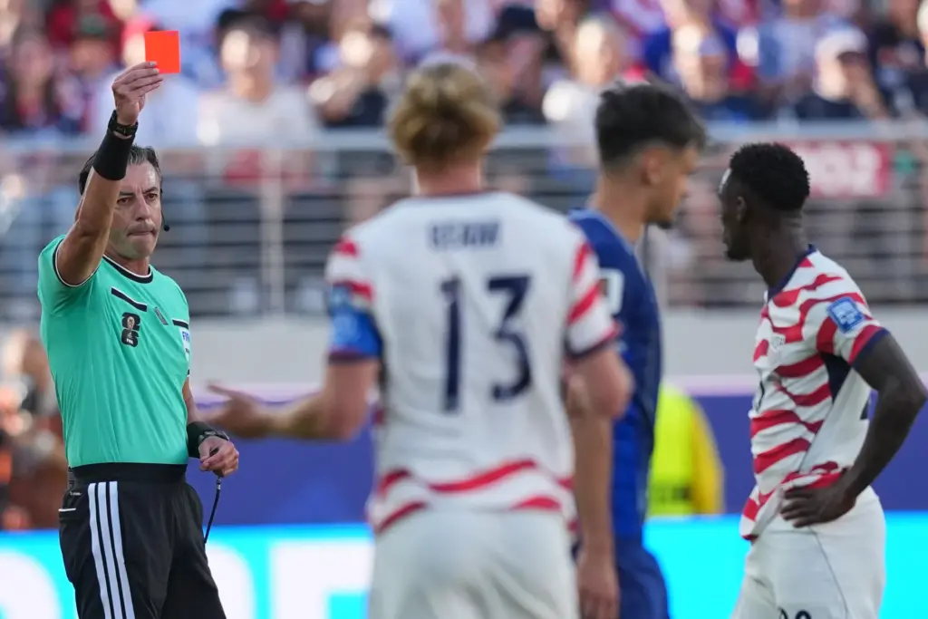 Referee Raphael Claus shows a red card to the United...