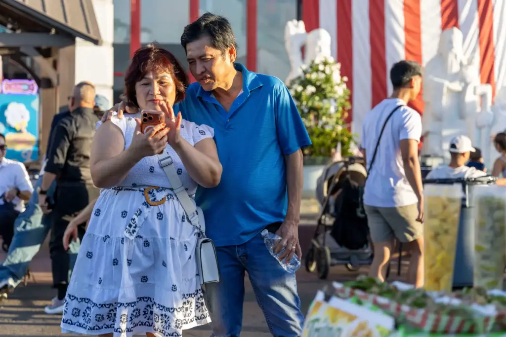 Thi Dep Ngo (left) takes selfies with her husband, Toan...