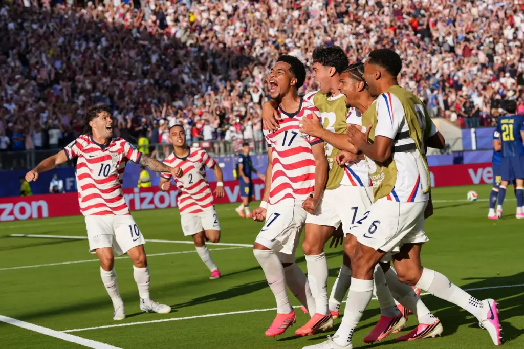 United States’ Malik Tillman (17) celebrates with teammates after scoring...
