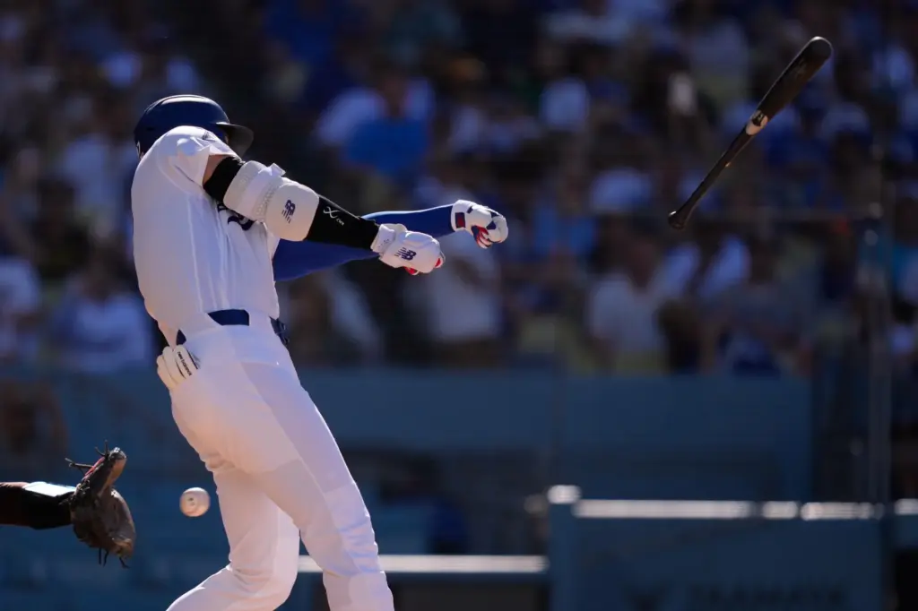 Dodgers’ Shohei Ohtani loses his bat during the third against...