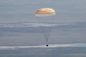 A US-Russian space crew lands safely in Kazakhstan after an 8-month stint on the ISS