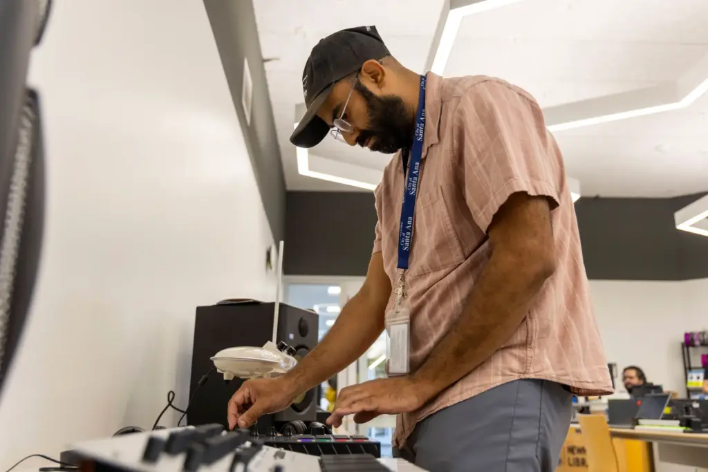Library Associate Abner Rios makes a beat on the new...