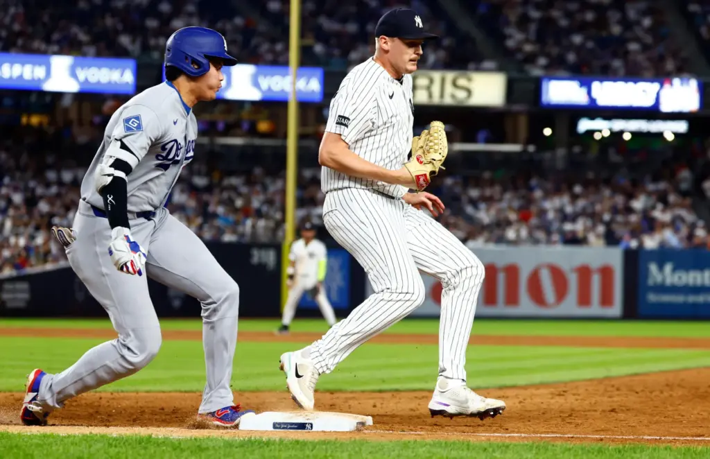 New York Yankees pitcher Brent Headrick, right, beats Dodgers’ Shohei...