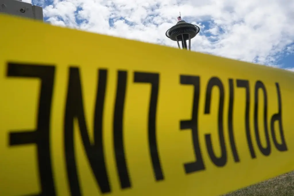 Police tape cordons off an area near the Space Needle...