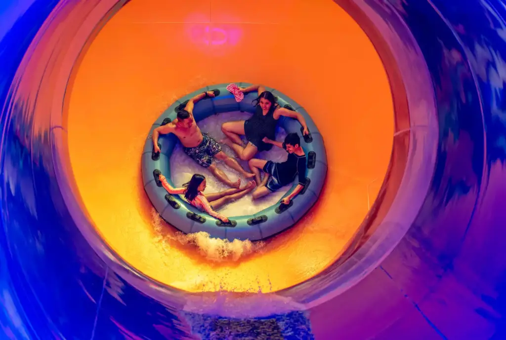 A family holds onto their raft as they ride the...