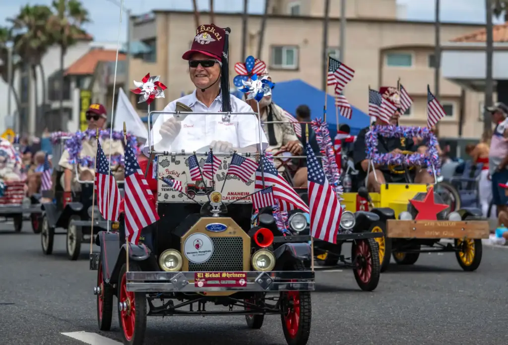 Shriners volunteers drive miniature cars along Pacific Coast Highway in...