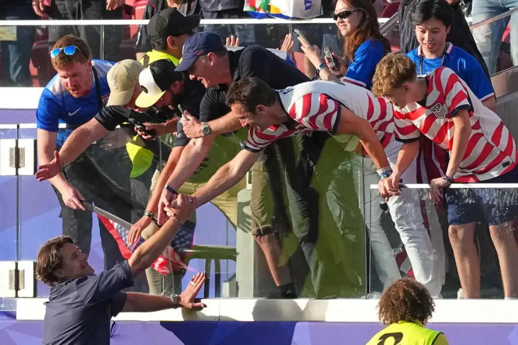 United States head coach Mauricio Pochettino celebrates with supporters.