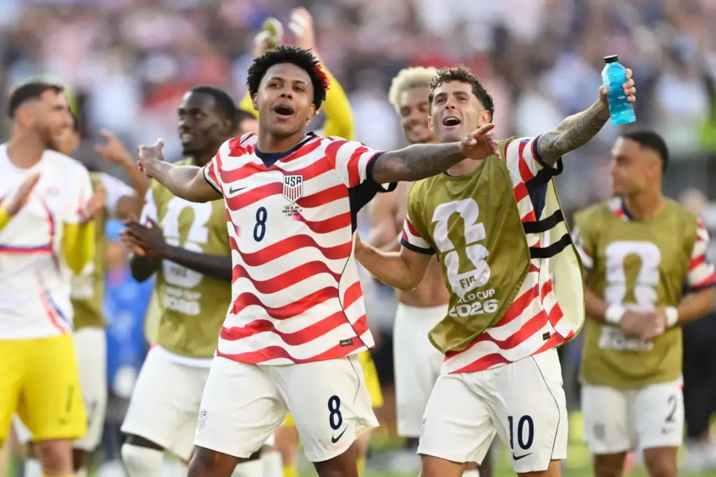 Weston McKennie and Christian Pulisic celebrate winning the World Cup round of 32 match.