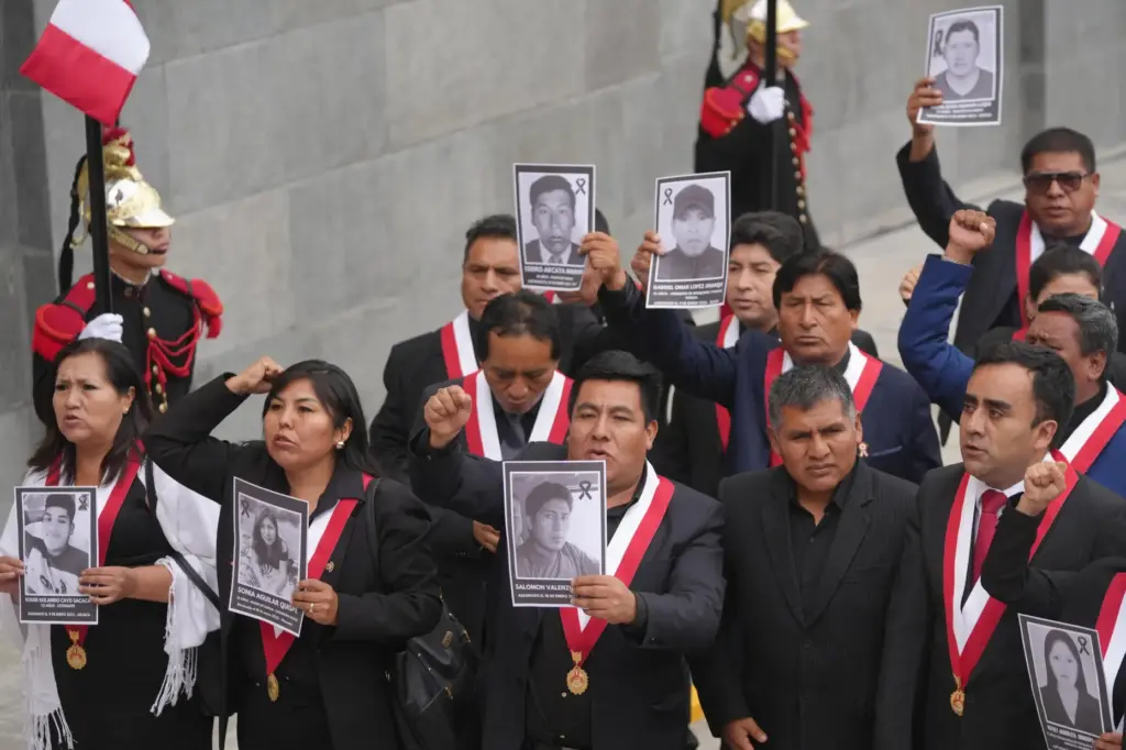Opposition lawmakers hold photos of people killed during protests following...