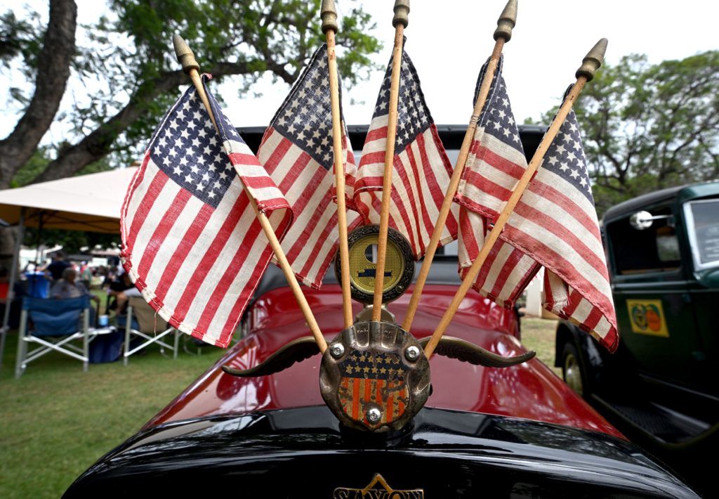 A 1915 Saxon is festooned with flags. Fourth of July...