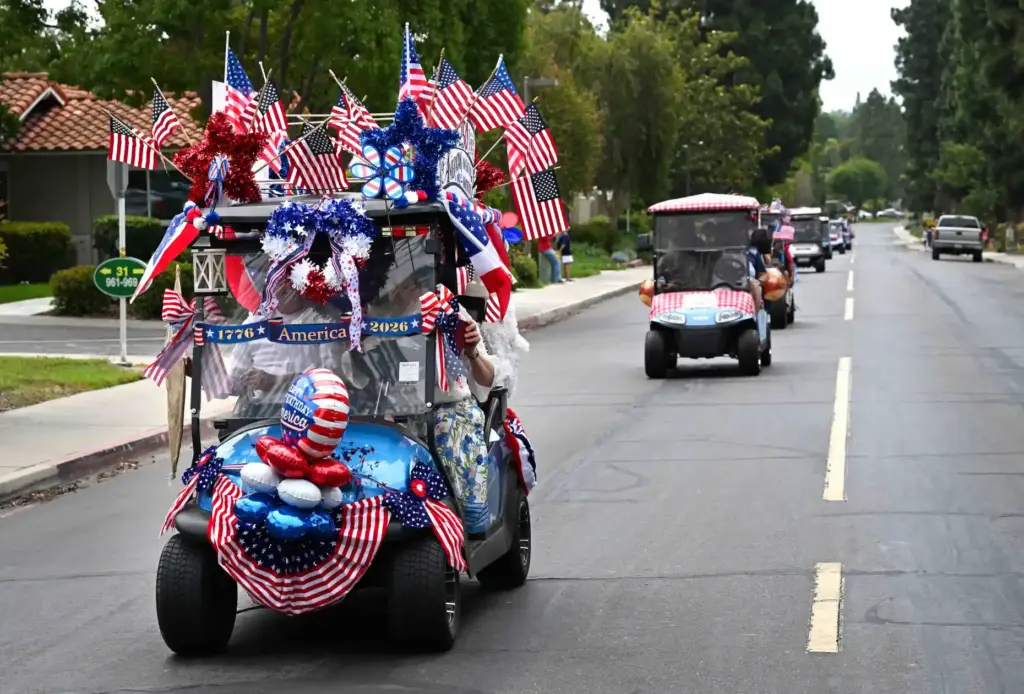 Decorated golf carts ride down Calle Aragon road during the...