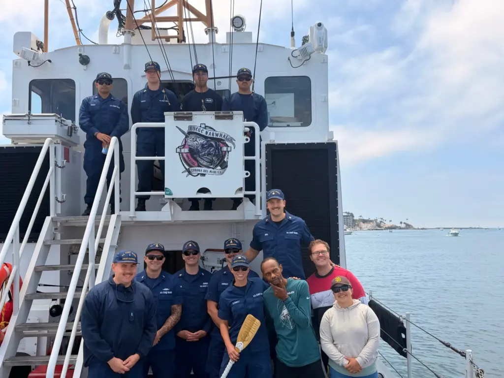 Lt. Jake Monson stands with his crew aboard the Narwhal,...