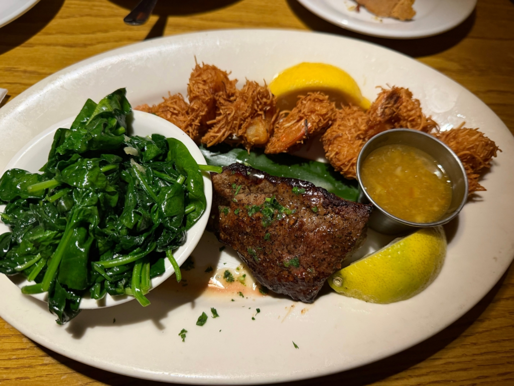 A steak and coconut shrimp combo is seen at Damonâs...