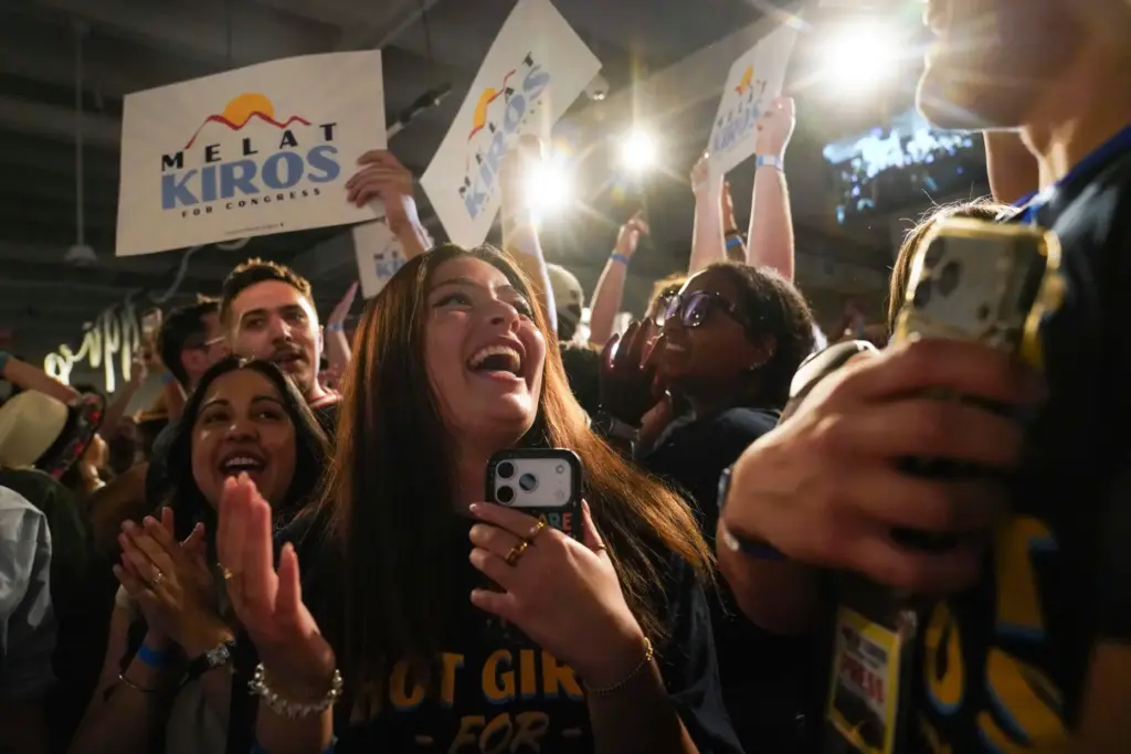 Attendees celebrate after congressional candidate Melat Kiros won the Democratic nomination.