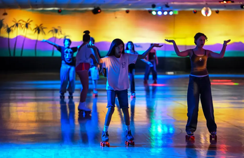 Skaters dance to YMCA as they skate around the rink...