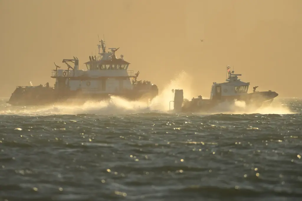 Search and rescue vessels look for missing victims.