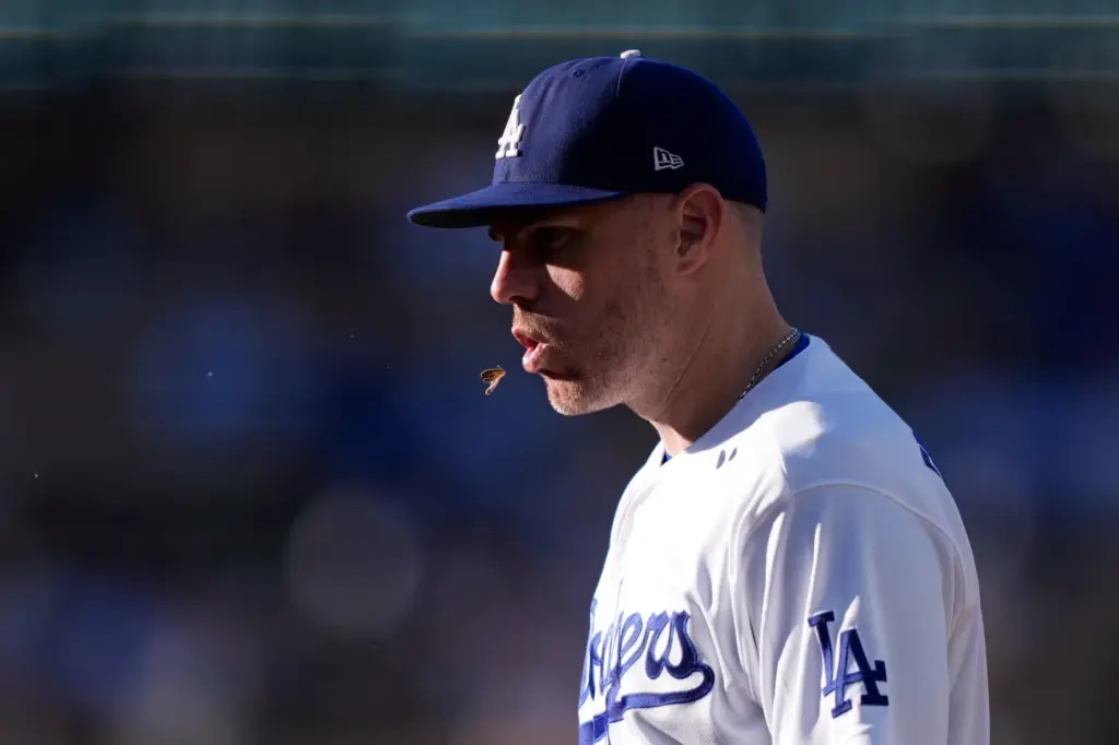 Dodgers first baseman Freddie Freeman spits seeds during the sixth...