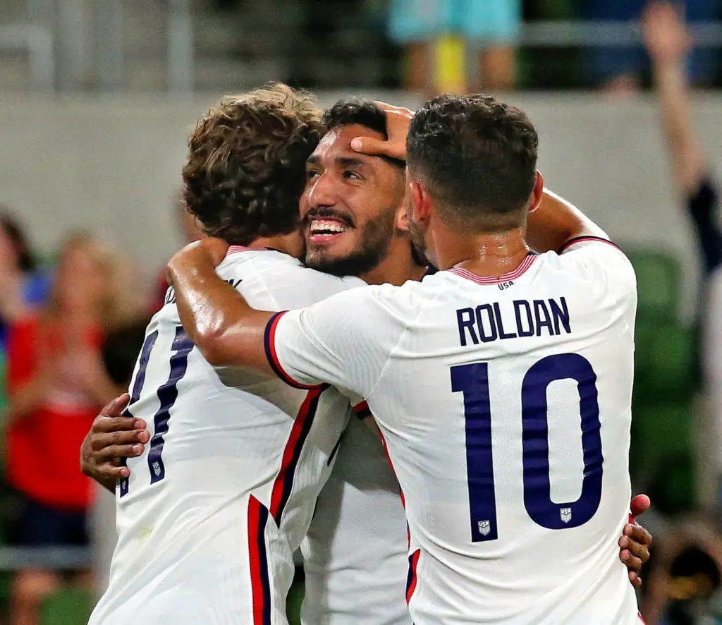 The United States’ Jesus Ferreira, center, is congratulated by Brenden...