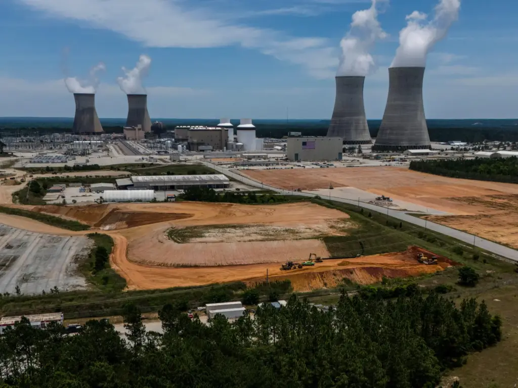 FILE – The four nuclear reactors and cooling towers operate...