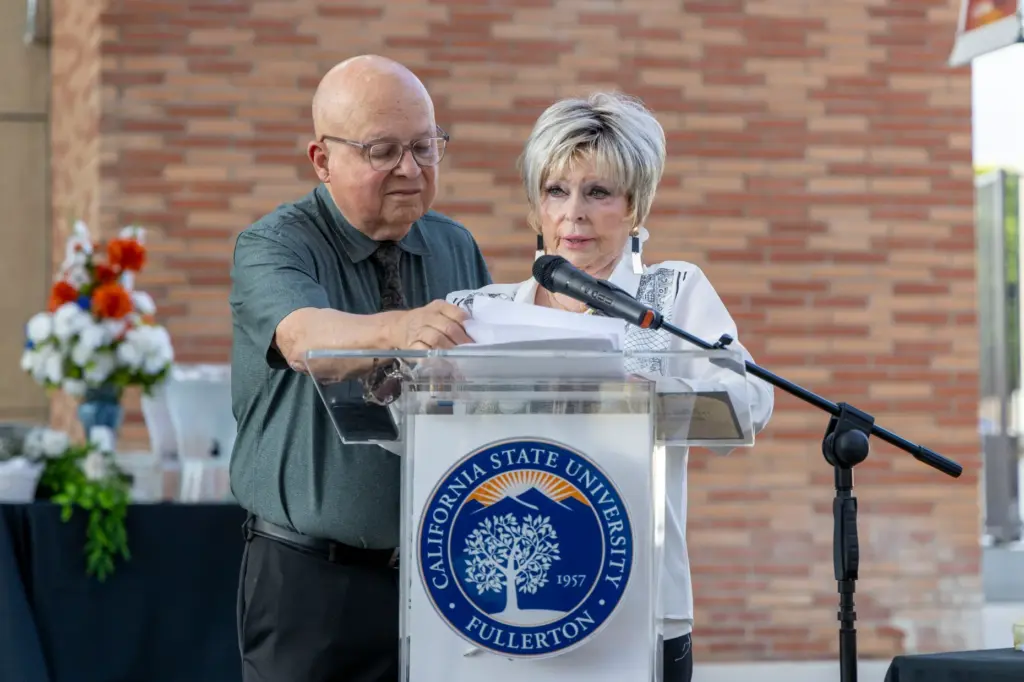 Joe Almazan (left) helps Pat Almazan, whose father was a...