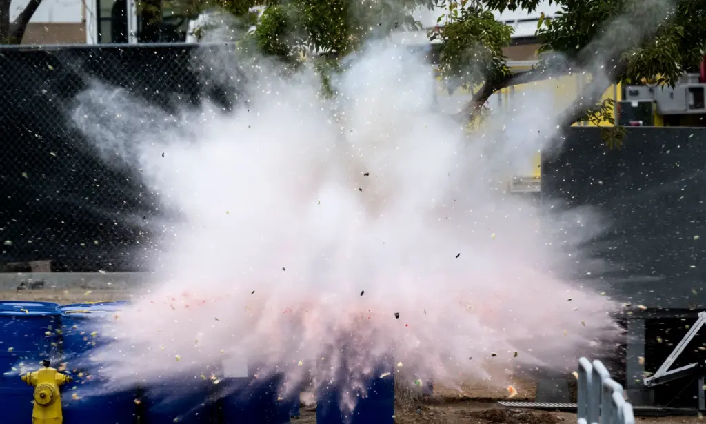 Officials detonate the top of an aerial rocket inside a...