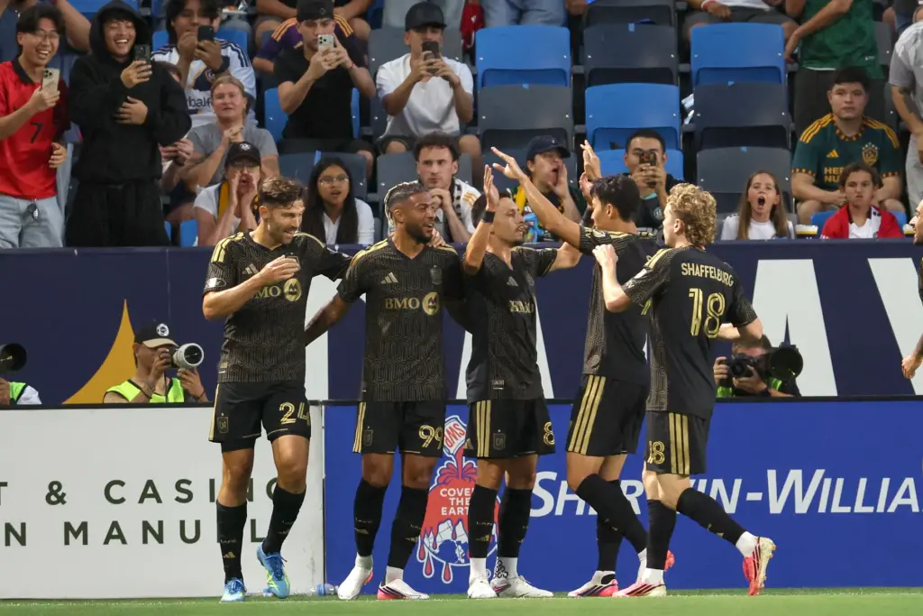 LAFC midfielder Mark Delgado, center, celebrates with teammates after he...