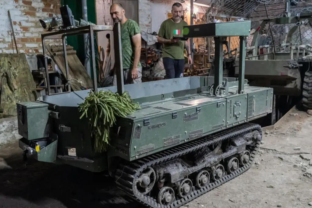 Ukrainian soldiers of Khartia brigade prepare a ground drone for a mission.