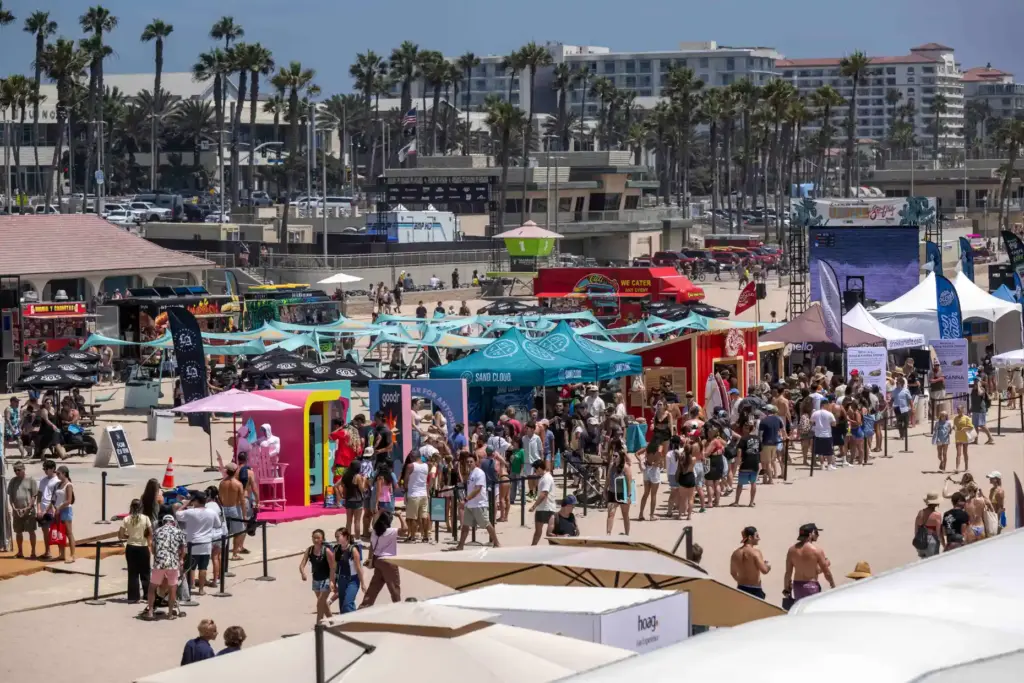 Hundreds of surf fans hang out in the temporary village,...
