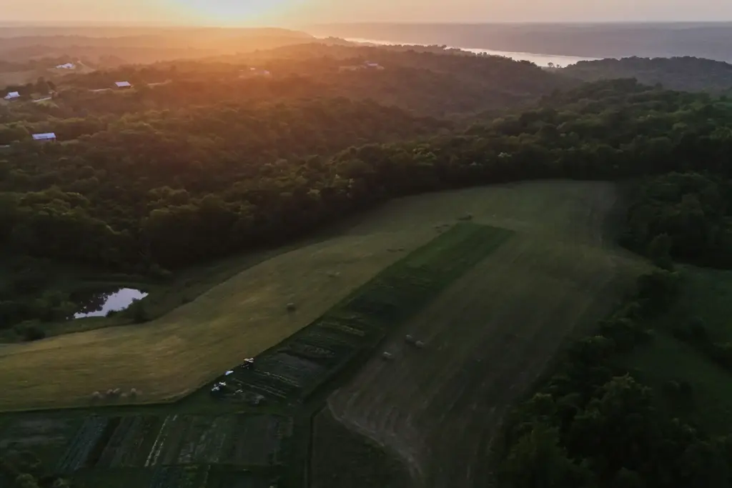 The sun sets over a farm in Brooksville, Kentucky.